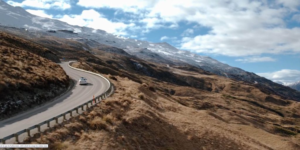 Taxi on a winding road above Lake Wakatipu